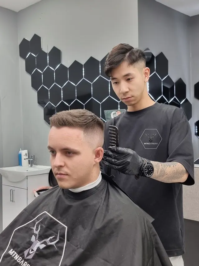 A barber combing a finished cut