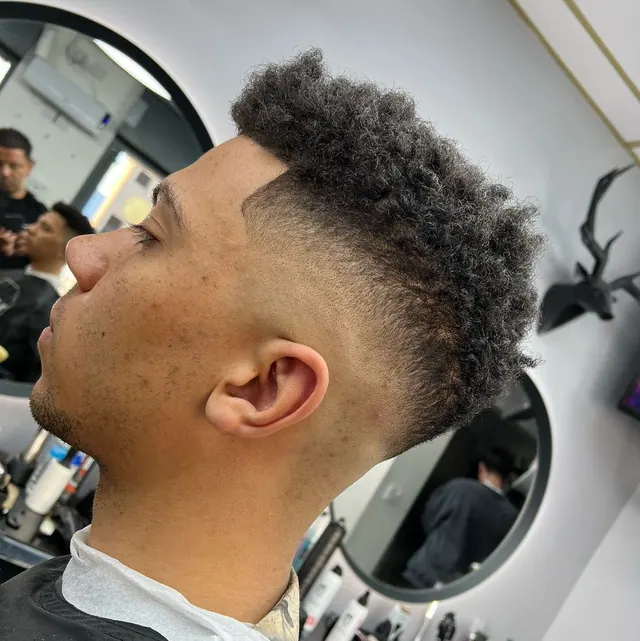 Curly top with a high fade